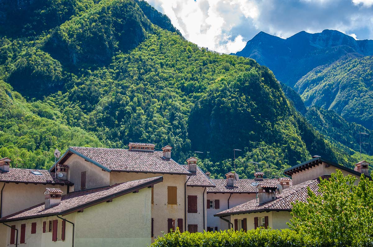 The village's houses against the lush mountains - Venzone, Italy - rossiwrites.com