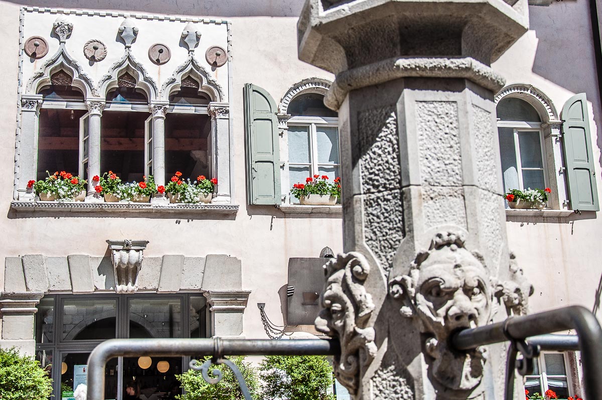 The water spouts of the fountain and a facade with Venetian windows - Venzone, Italy - rossiwrites.com