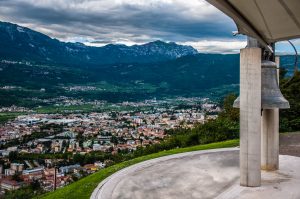 The Bell of the Fallen against a panoramic view of the city of Rovereto - Trentino, Italy - rossiwrites.com