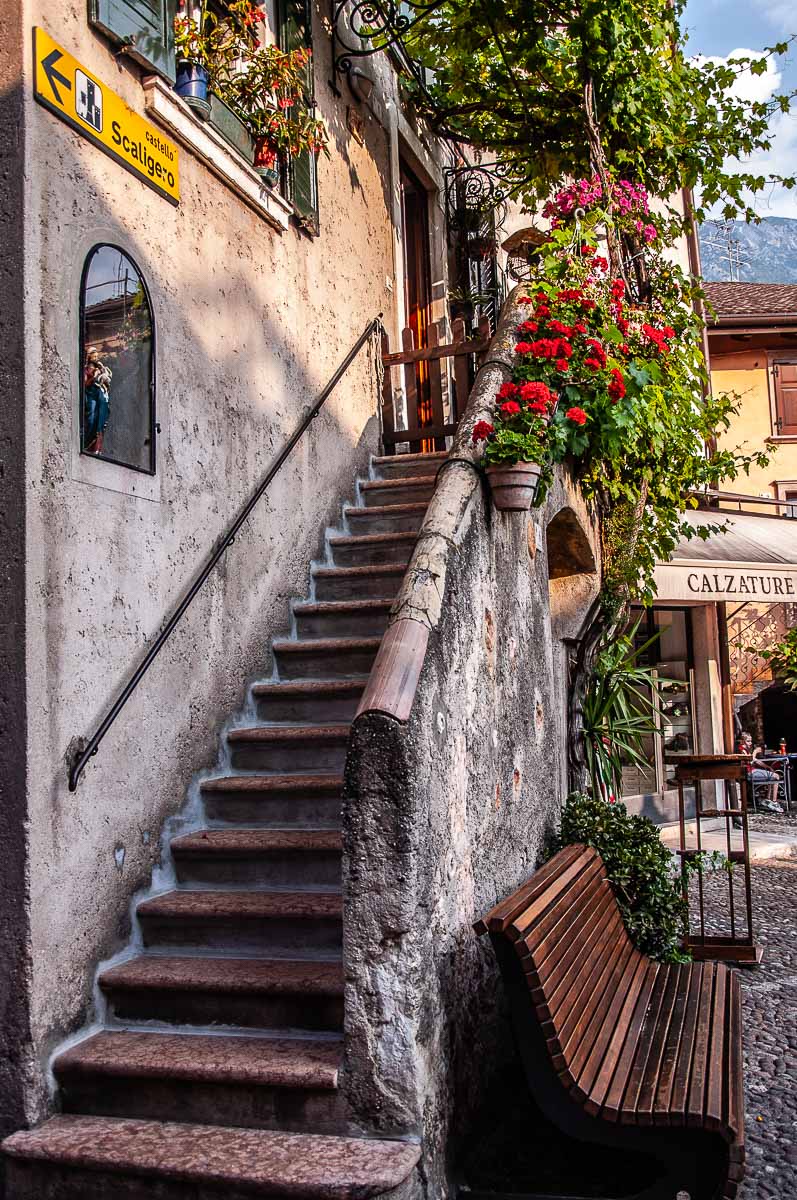 Steps leading to the door of an old house in the historic centre - Malcesine, Italy - rossiwrites.com