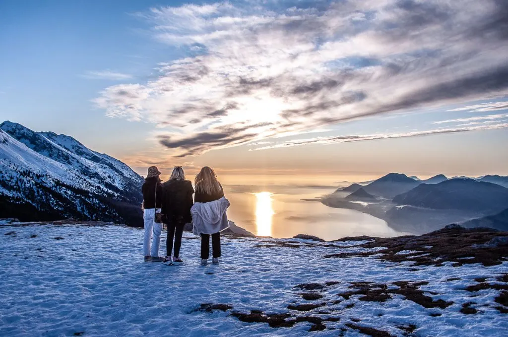 Sunset over Lake Garda seen from the snow-capped Monte Baldo in winter - Malcesine, Italy - rossiwrites.com