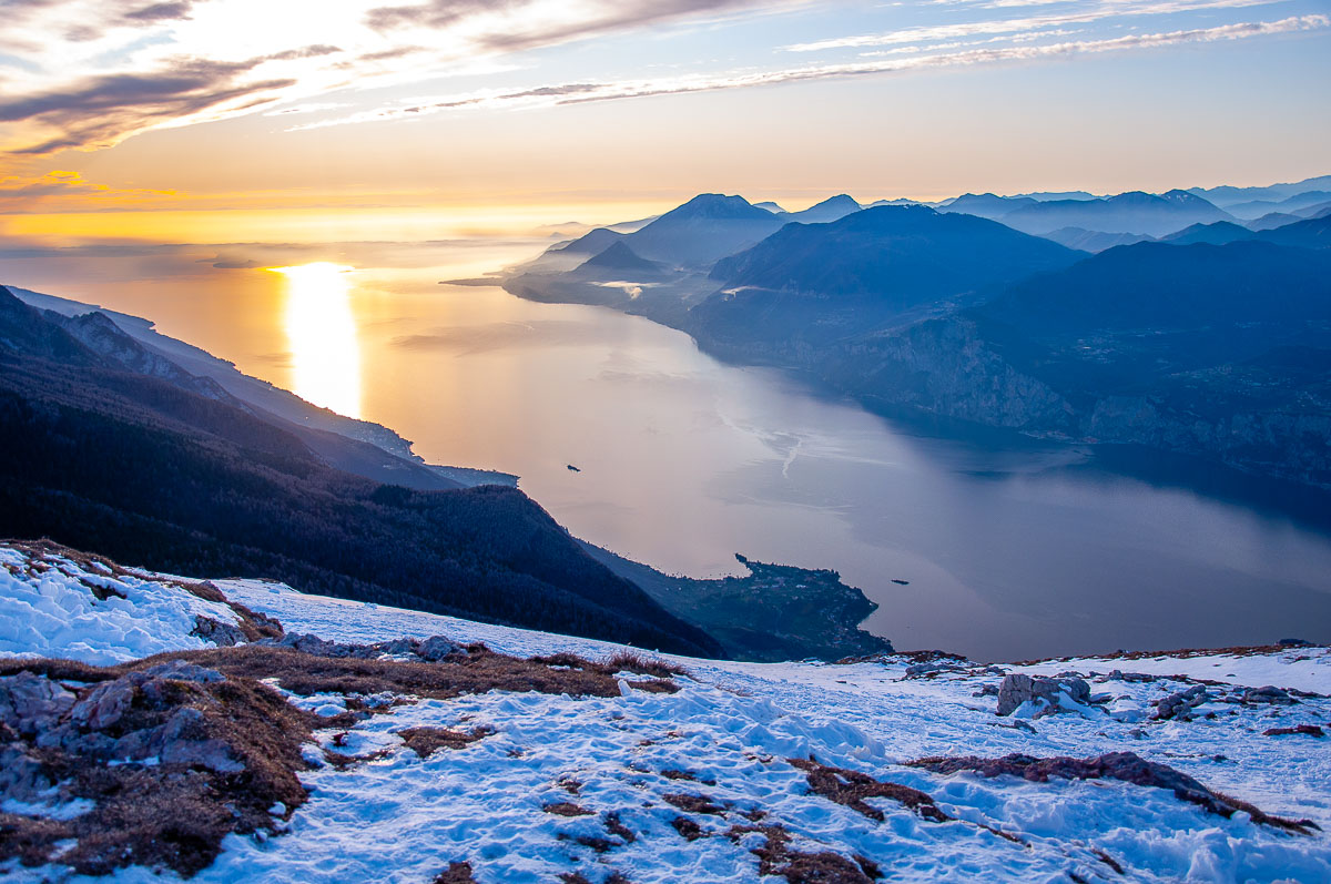 Sunset over Lake Garda seen from the snow-capped Monte Baldo in winter - Malcesine, Italy - rossiwrites.com