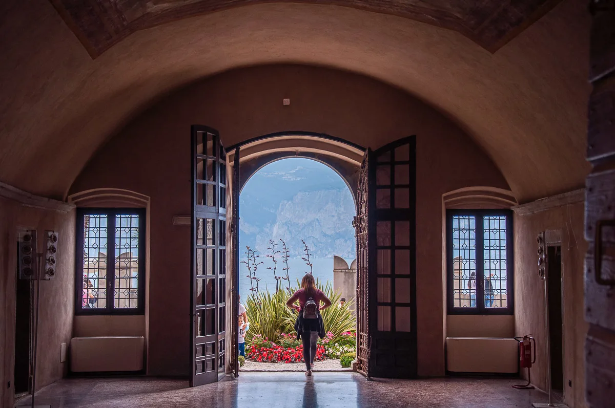 The ground floor hall of the Palazzo dei Capitani with the large door open to the garden - Malcesine, Italy - rossiwrites.com