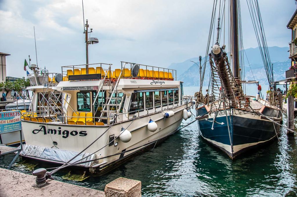 Tourist boats in the harbour in the historic centre with a view of Lake Garda - Malcesine, Italy - rossiwrites.com