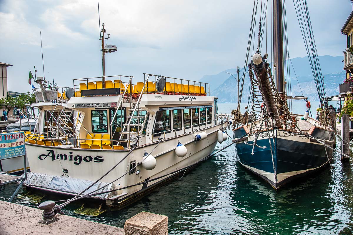 Tourist boats in the harbour in the historic centre with a view of Lake  Garda - Malcesine, Italy  - Rossi Writes