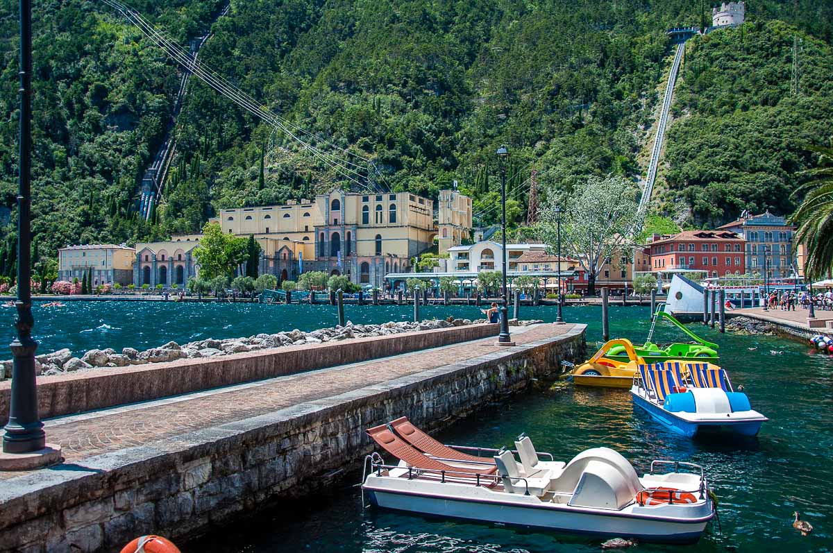 The harbour with pedalos and the Hydroelectric station - Riva del Garda, Italy - rossiwrites.com
