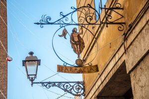 The sign of a historic pharmacy in Vicenza, Italy - rossiwrites.com