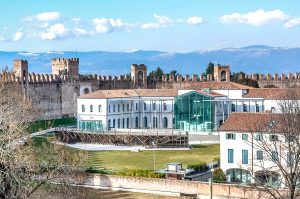 The Andrea Mantegna Town Hall with the defensive wall and snow-capped mountains behind it - Cittadella, Italy - rossiwrites.com