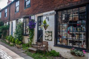 A cute gift shop on a side street decorated with plants and potted flowers - Rye, England - rossiwrites.com
