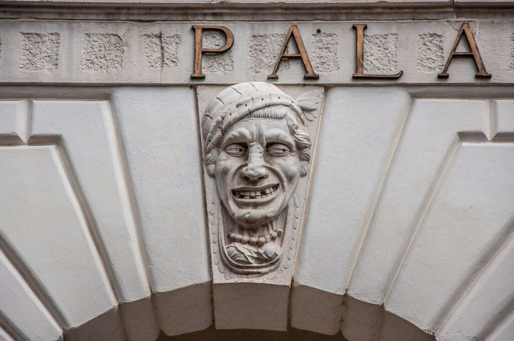 A grotesque face on the facade of the Palazzo del Governo - Brescia, Italy - rossiwrites.com