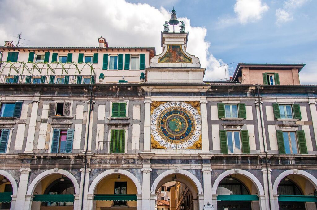 The portico with the astronomical clock on Piazza della Loggia - Brescia, Italy - rossiwrites.com