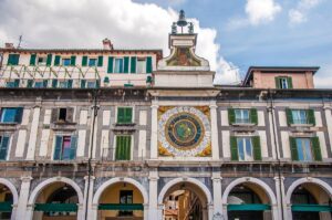 The portico with the astronomical clock on Piazza della Loggia - Brescia, Italy - rossiwrites.com