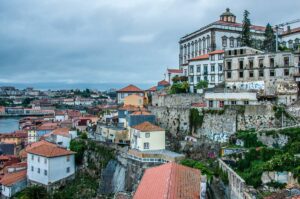 Panorama at dusk of the Episcopal Palace from the top of the Dom Luis I Bridge - Porto, Portugal - rossiwrites.com