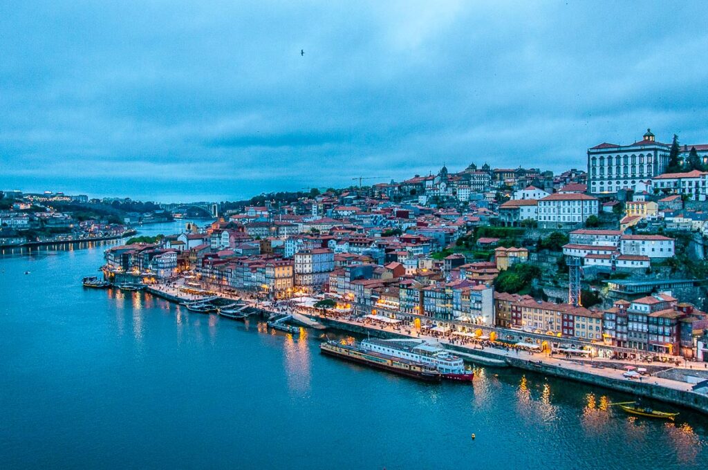 A dusk panorama of the River Douro and the historic centre from the top of of Dom Luis I Bridge - Porto, Portugal - rossiwrites.com