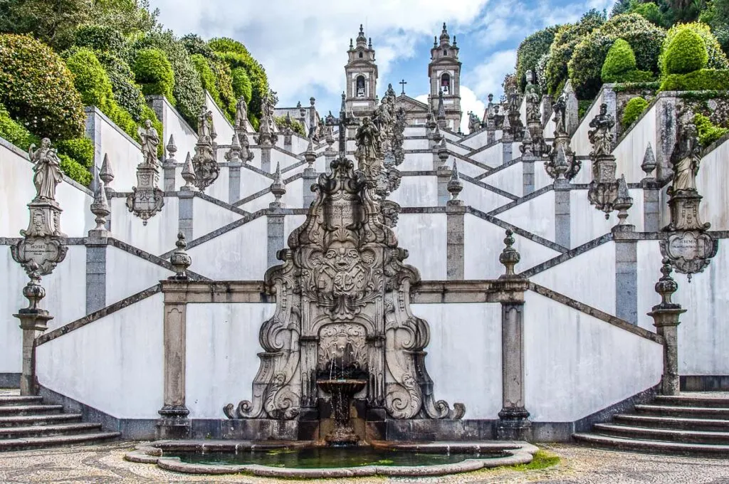 A fountain and the flights of the Stairway of the Five Senses leading to the Sanctuary of Bom Jesus do Monte - Braga, Portugal - rossiwrites.com