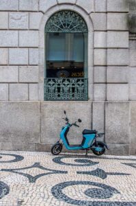 A tiny bike parked near an arched window on Rua da Santa Caterina - Porto, Portugal - rossiwrites.com