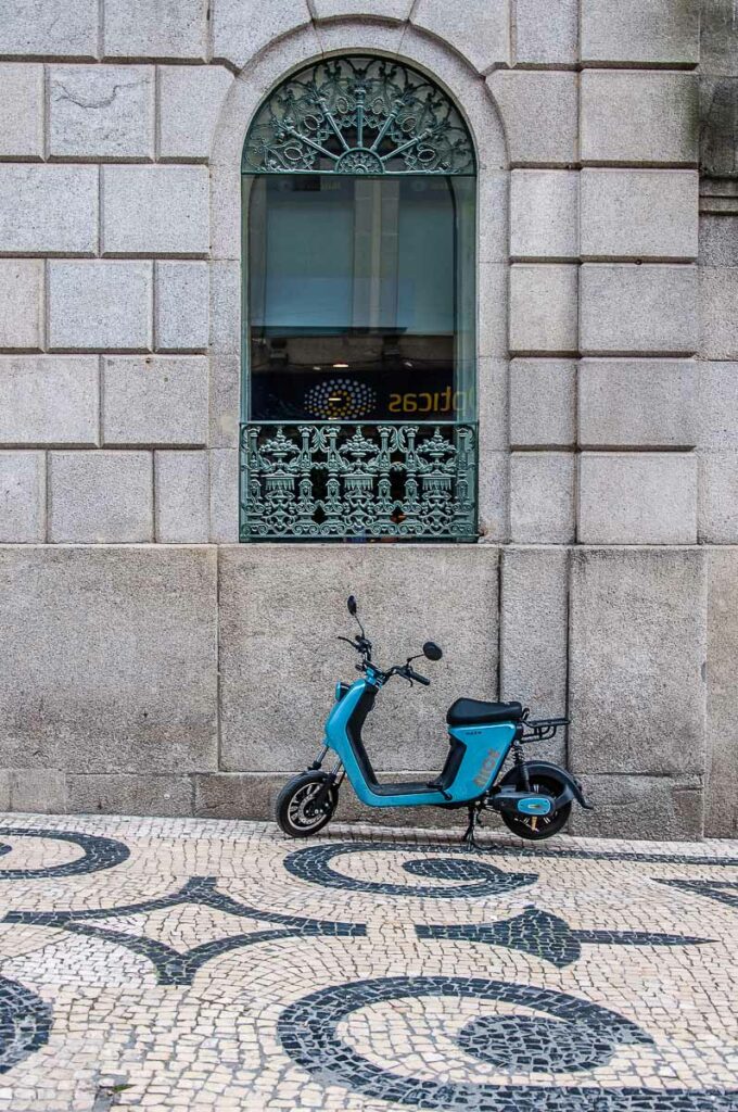 A tiny bike parked near an arched window on Rua da Santa Caterina - Porto, Portugal - rossiwrites.com