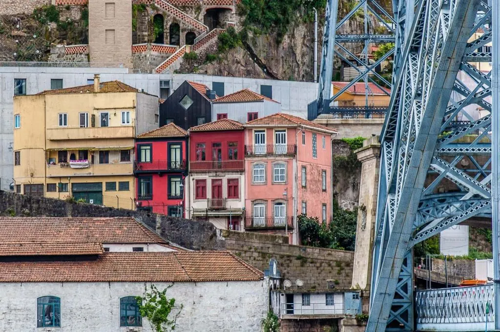 Colourful houses huddled near the Dom Luis I Bridge - Porto, Portugal - rossiwrites.com