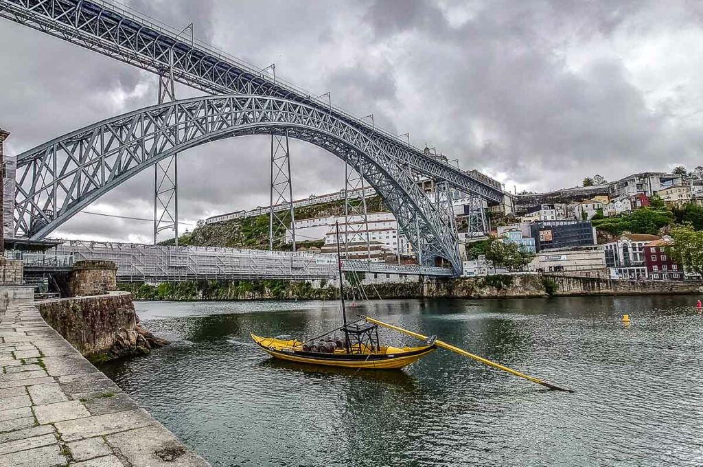 Dom Luis I Bridge with a yellow boat - Porto, Portugal - rossiwrites.com