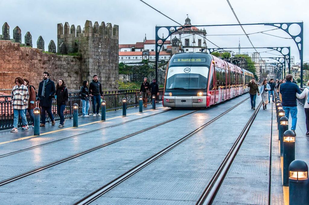 Electric train on top of of Dom Luis I Bridge - Porto, Portugal - rossiwrites.com