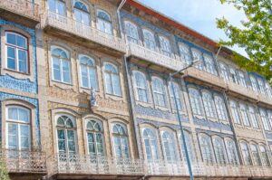 Facades covered with azulejos in yellow and blue along Largo do Toural - Guimarães, Portugal - rossiwrites.com