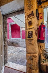 Small bar with signs showing the historic flood levels - Porto, Portugal - rossiwrites.com