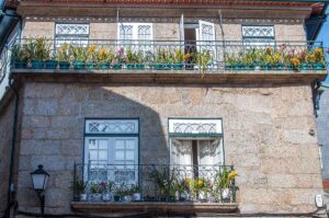 Balconies with blooming orchids - Guimaraes, Portugal - rossiwrites.com