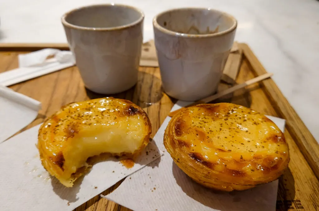 Freshly baked pasteis de nata served with two cups of espresso - Porto, Portugal - rossiwrites.com