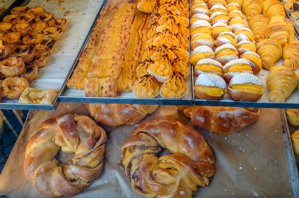 The display of a typical Portuguese patisserie laden with traditional desserts and pastries - Braga, Portugal - rossiwrites.com