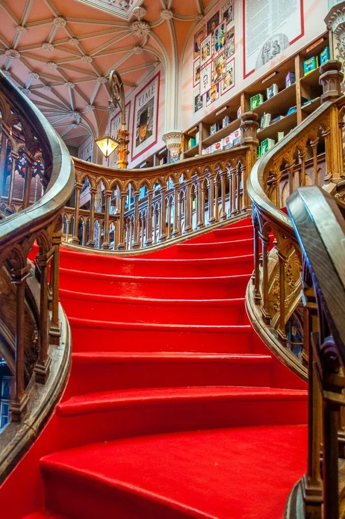 The iconic red staircase in the historic Livraria Lello & Irmao - Porto, Portugal - rossiwrites.com