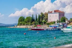 Beautiful pink house on the seafront of the island of Zlarin in the Sibenik Archipelago - Dalmatia, Croatia - rossiwrites.com