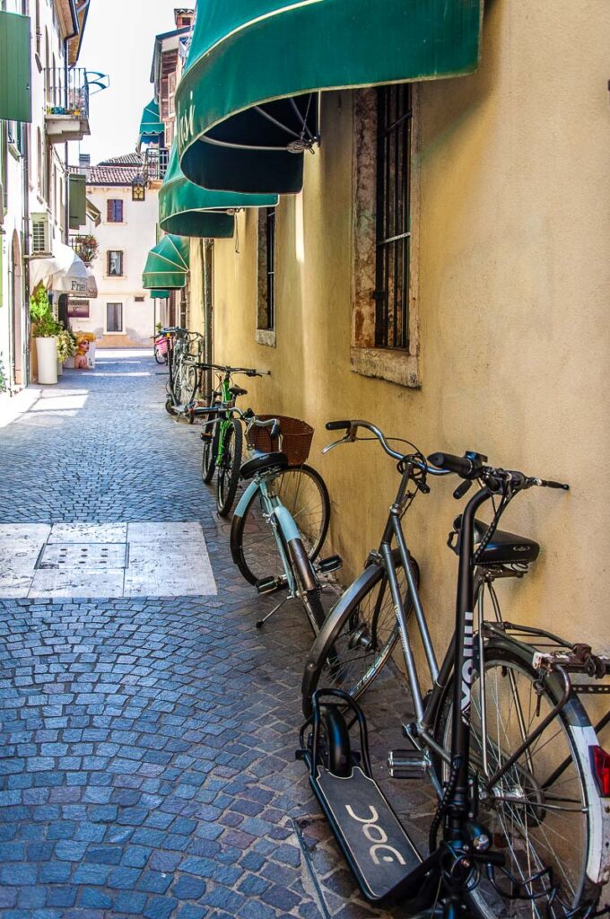 Bikes leaning against the wall of a local hotel in the town of Lazise - Lake Garda, Italy - rossiwrites.com