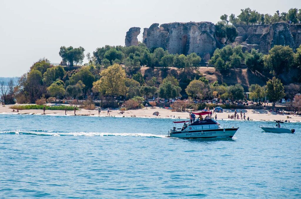 Boat with Jamaica Beach with Grotte di Catullo - Sirmione, Lake Garda, Italy - rossiwrites.com