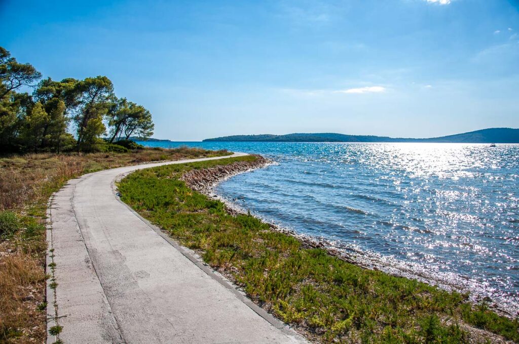 The promenade brimming the forest on the island of Krapanj in the Sibenik Archipelago - Dalmatia, Croatia - rossiwrites.com