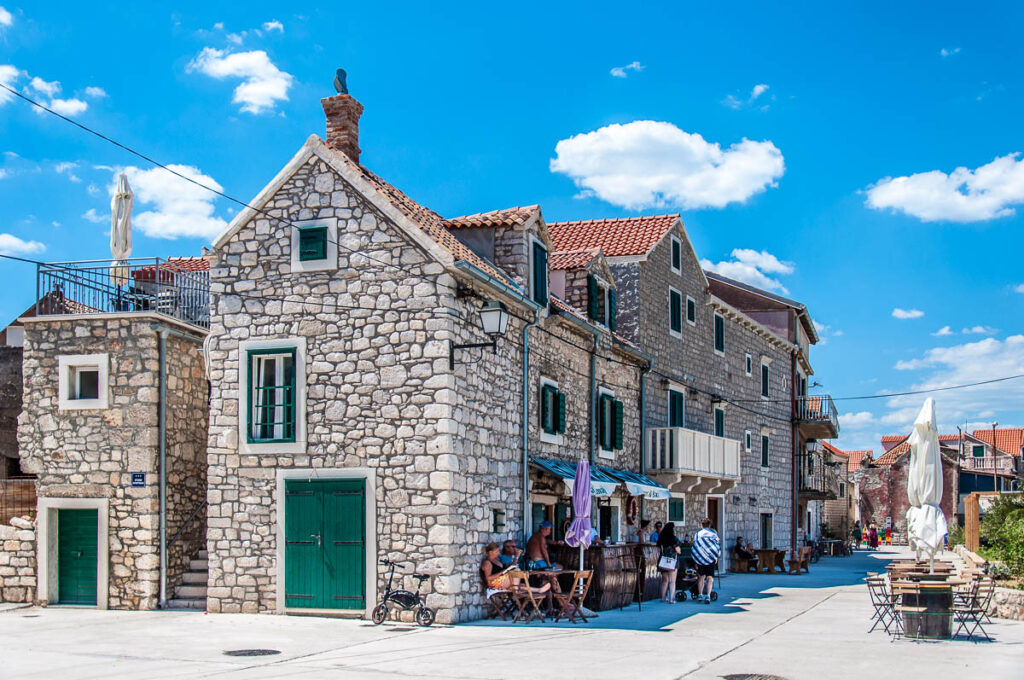 Traditional stone houses and a small bar on the island of Krapanj in the Sibenik Archipelago - Dalmatia, Croatia - rossiwrites.com