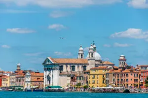 The Fondamenta delle Zattere with the Church of Gesuati and a plane - Venice, Italy - rossiwrites.com
