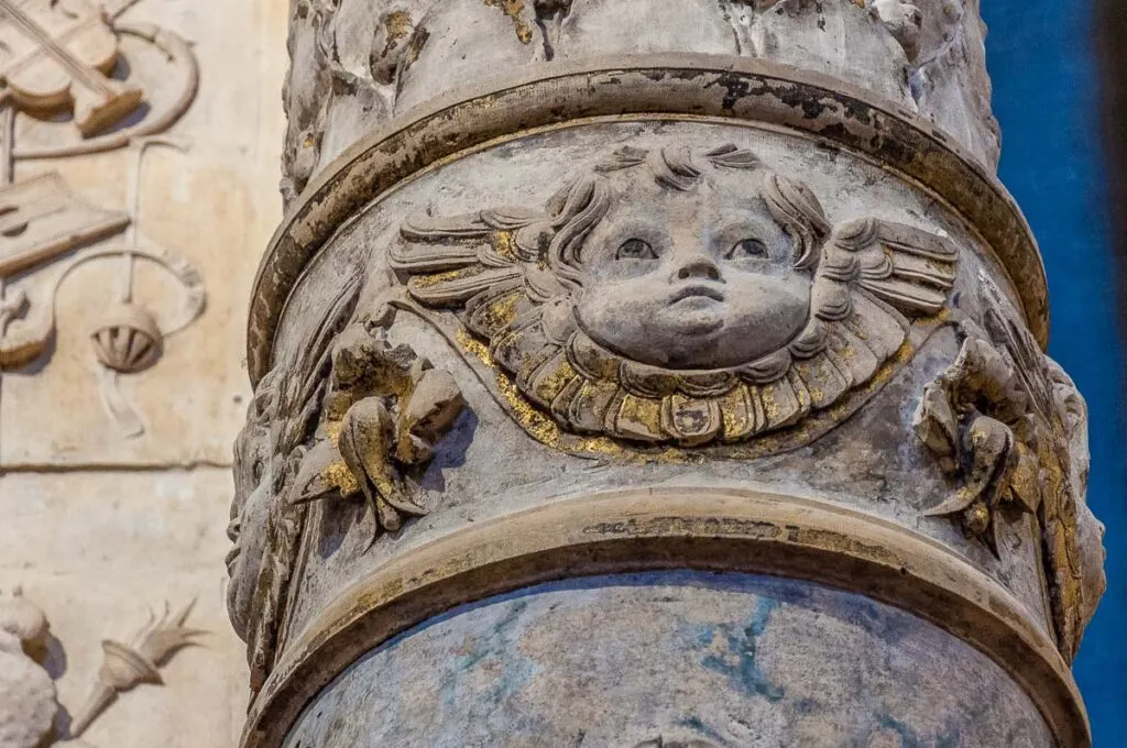 Cherub on the carved altar framing Giovanni Bellini's Baptism of Christ - Vicenza, Italy - rossiwrites.com