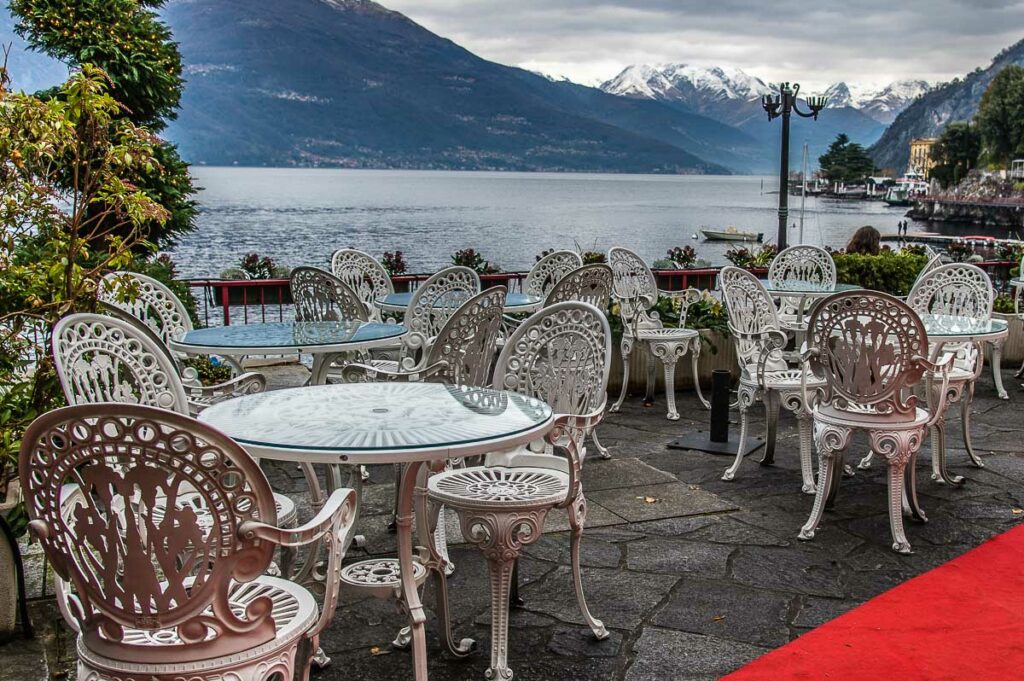 The empty outside seating area of a small restaurant in the town of Varenna - Lake Como, Italy - rossiwrites.com