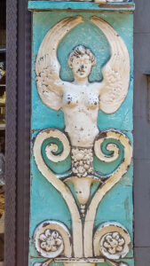 A bas-relief of the siren Partenope decorating a small bakery - Naples, Italy - rossiwrites.com