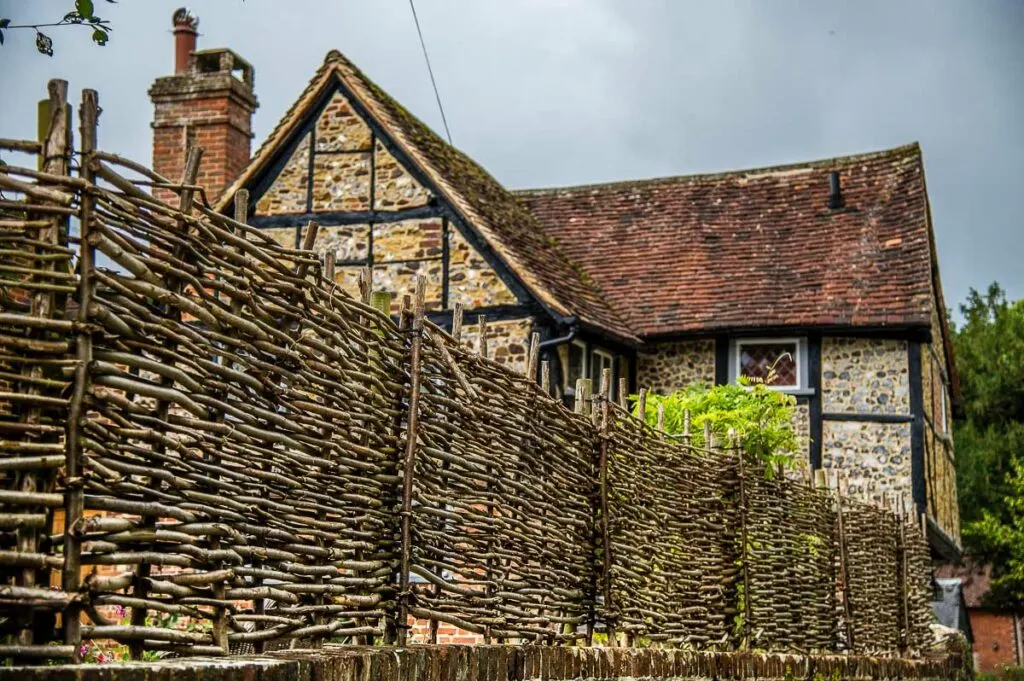 An old house with an interesting fence made of sticks in the village of Shere - Surrey, England - rossiwrites.com