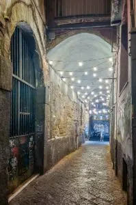 Dark portico leading away from Via dei Tribunali - Naples, Italy - rossiwrites.com