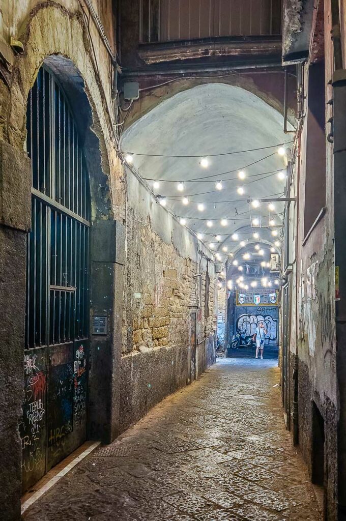Dark portico leading away from Via dei Tribunali - Naples, Italy - rossiwrites.com