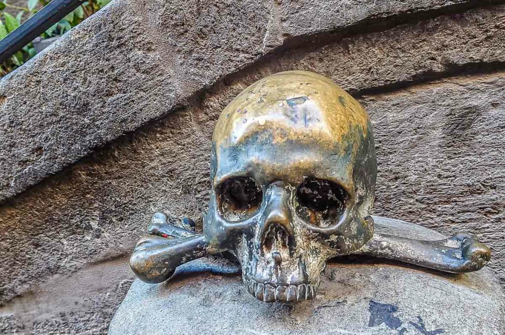 Metal skull in front of the Church of the Purgatory - Naples, Italy - rossiwrites.com