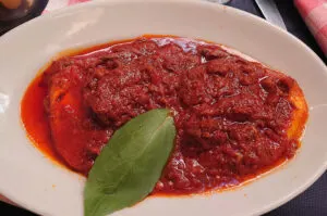 Slices of Provolone cheese topped with ragu sauce as served in the Restaurant Tandem - Naples, Italy - rossiwrites.com