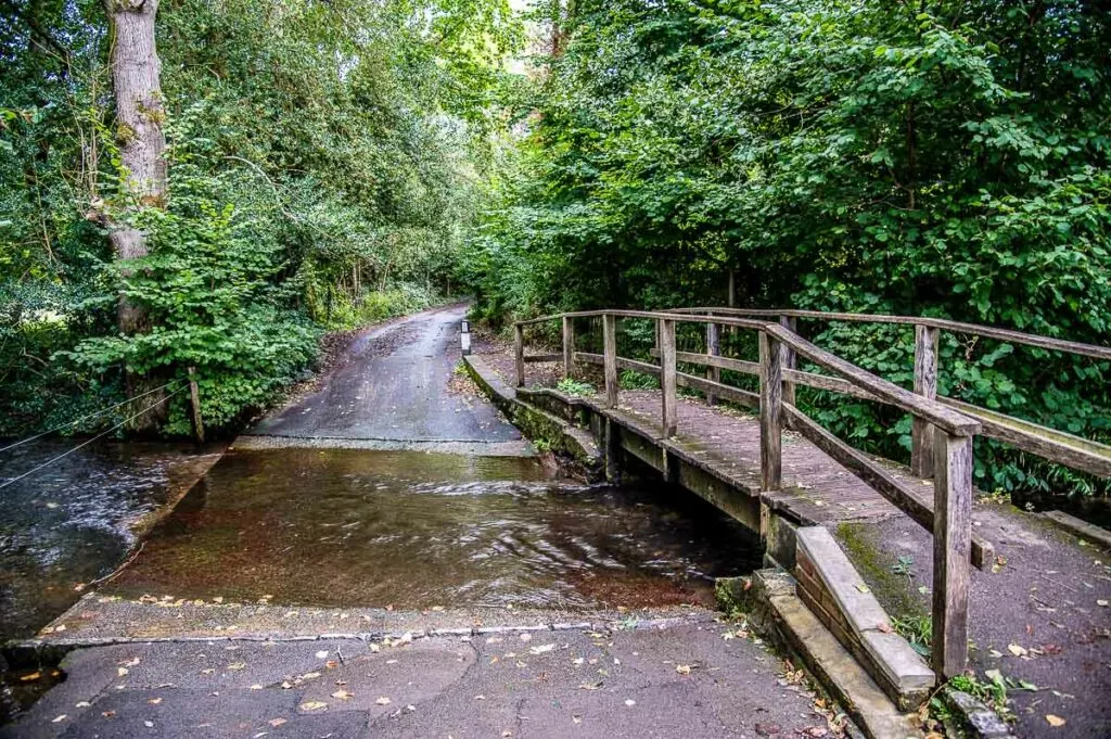 The River Tillingbourne with a small wooden bridge in the village of Shere - Surrey, England - rossiwrites.com