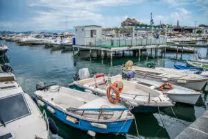 The harbour of Mollo di Baia with the Aragonese Castle in the distance - Naples, Italy - rossiwrites.com
