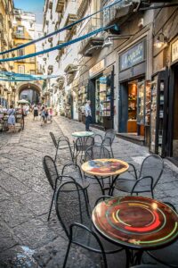 The tables of a coffee shop placed on the street in the historic centre - Naples, Italy - rossiwrites.com