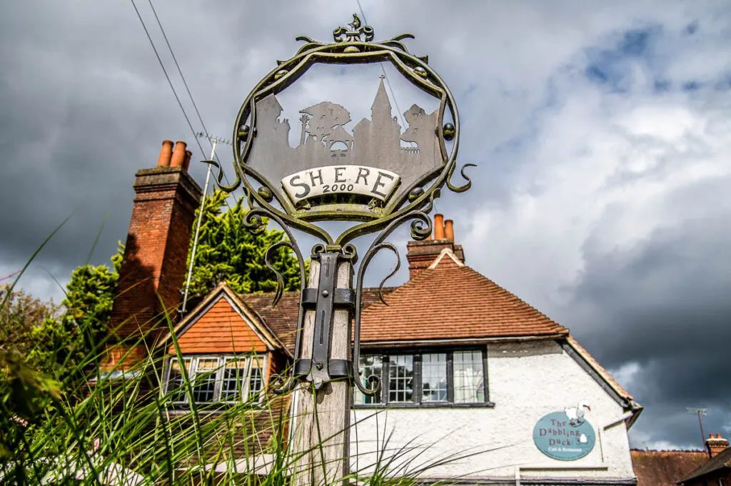 The village sign with the Dabbling Duck cafe in the village of Shere - Surrey, England - rossiwrites.com