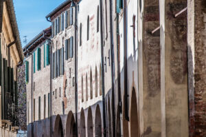 The facades of historic houses flanking a narrow street - Treviso, Italy - rossiwrites.com