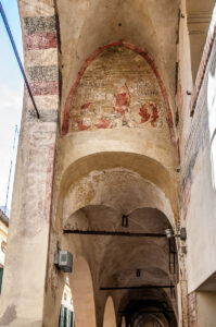 Traditional portico with faded frescoes - Treviso, Italy - rossiwrites.com